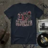 Navy t-shirt with "I Love Brooklyn" text, a rock on hand symbol, and a fiery heart graphic