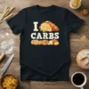 Black t-shirt with "I LOVE CARBS" text and illustrations of a croissant, bagels, pancakes, and bread