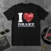 I Love Drake T-Shirt featuring a distressed white 'I', a red heart graphic, and metallic 'DRAKE' text