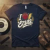 Navy blue t-shirt with "I Love Elvis" text design featuring a flaming heart, lightning bolt, and vintage gold accents