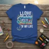 I LOVE FISHING WITH THE BEST CATCH OF MY LIFE quote on a blue t-shirt with fishing graphics and a