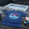 I Love Hot Tubs graphic t-shirt with a neon heart and geometric mountain design in a circle