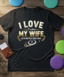 Black t-shirt with "I LOVE It when MY WIFE LETS ME PLAY DISC GOLF" text and disc golf graphic