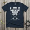 Navy t-shirt with white text "I Love It When She Bends Over" and crossed fishing rods graphic
