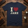 Navy blue t-shirt with distressed "I Love Jake" text and a cracked red heart graphic