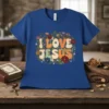 I LOVE JESUS text with floral border on a royal blue t-shirt, retro groovy font style