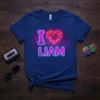 Neon I Love Liam heart graphic t-shirt in vibrant pink and blue on a royal blue tee