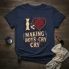 I Love Making Boys Cry Cry text with a cracked heart graphic on a navy t-shirt, vintage distressed style