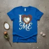 Blue t-shirt with "I LOVE ME" text and a heart-shaped mirror surrounded by roses design