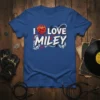 Blue t-shirt with "I LOVE MILEY" text in white and red, featuring a flaming heart with barbed wire and skull