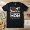 I Love My Beautiful Boyfriend's Mom text design with a red heart and floral accents on a black t-shirt