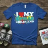 I Love My Bipolar Girlfriend text design with a red heart and colorful paint splatters on a blue t-shirt