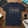 Navy blue t-shirt with "I Love My Geek." text and circuit board graphics, featuring a red heart and gaming controller