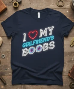 Navy t-shirt with neon-style text: I Love My Girlfriend's Boobs, featuring a red heart and concentric circles on the word