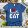 I Love My Girlfriend's Cat text with a red heart graphic on a blue t-shirt, featuring distressed white lettering