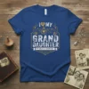 I Love My Grand Daughter My Greatest Adventure t-shirt with heart and shield graphic in gold and white on blue