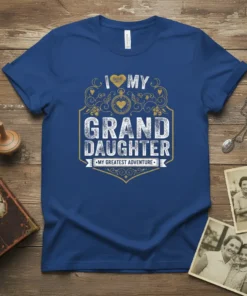 I Love My Grand Daughter My Greatest Adventure t-shirt with heart and shield graphic in gold and white on blue