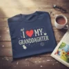 I Love My Granddaughter text with heart and teddy bear graphic on a navy blue t-shirt