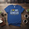 I Love My Guncles text with rainbow heart and decorative elements on a blue t-shirt