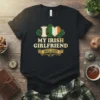 Black t-shirt with "I Love My Irish Girlfriend Ireland" text and an Irish flag heart graphic, surrounded by shamrocks
