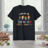 T-shirt with "I Love My Job For All The Little Reasons" text and cartoon children, pencil, and apple graphics
