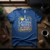 I Love My Latina Wife So Please Stay Awam Me quote on a blue t-shirt with ornate gold and white