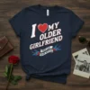 I Love My Older Girlfriend True Love Never Gets Old text with heart and swallow graphics on a navy t-shirt