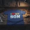 I Love My Son text with a red heart and bold "SON" graphic on a blue t-shirt
