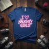 I Love Naughty Girls text graphic with heart symbol and pink/white spray paint splatters on a blue t-shirt