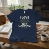I Love Not Camping text with graphic of person lounging on a couch on a navy t-shirt