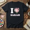 I Love Sarah t-shirt with a white 'I', a floral heart graphic, and 'Sarah' in pink lettering