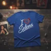 Blue t-shirt with "I Love Selena" text and a stylized heart graphic, celebrating the iconic singer Selena Quintanilla