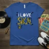 I LOVE SKA text design with black and yellow stripes on a blue t-shirt, featuring a silhouette of a musician
