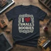 I Love Small Boobies T-Shirt featuring a distressed heart and vintage decorative border. This funny adult humor graphic tee is