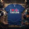Navy blue t-shirt with "I Love Taylor" text, a red heart, and a neon heartbeat graphic