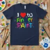 I love to Finger Paint text with a red heart and colorful paint splatters on a navy blue t-shirt