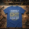 I Married A Fucking Idiot But He's My Fucking Idiot T-Shirt with bold yellow and white typography and a broken