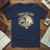 I Miss My Pug t-shirt with a sleeping pug wearing aviator goggles, surrounded by paw prints and a compass design
