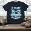 I Need 6 Or 7 Snow Days text with ice font and winter cabin graphic on navy t-shirt