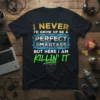 Black t-shirt with gold, blue, and green text: "I Never I'd Grow Up Be A Perfect Smartass But Here I