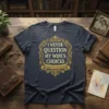 I NEVER QUESTION MY WIFE'S CHOICES quote on a dark t-shirt, featuring ornate golden lettering and a banner