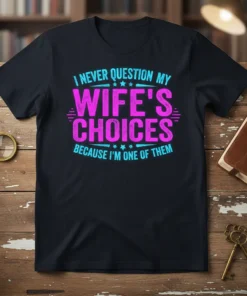 Black t-shirt with pink and blue text: "I Never Question My Wife's Choices Because I'm One of Them," celebrating husband's