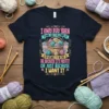 I Only Buy Yarn quote t-shirt featuring a basket of colorful yarn balls, knitting needles, and crochet hooks. Humorous design