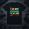 Black t-shirt with "I Pause My Game To Be Here You're Welcome" in white, red, and green text, featuring a