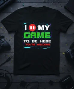 Black t-shirt with "I Pause My Game To Be Here You're Welcome" in white, red, and green text, featuring a