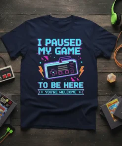 T-shirt with the text "I PAUSED MY GAME TO BE HERE YOU'RE WELCOME" and a retro game controller graphic