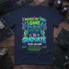 I Paused My Game To Graduate T-Shirt with gaming controller and wings graphic. Includes "You're Welcome" text and small print