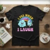 I Pee When I Laugh humorous quote t-shirt with cartoon cloud and water drop characters under a rainbow
