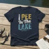 Navy t-shirt with distressed text "I PEE In The LAKE" and small fish graphics, perfect for lake lovers and fishermen