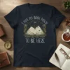 I Put My Book Down To Be Here quote on a dark navy t-shirt with an open book graphic